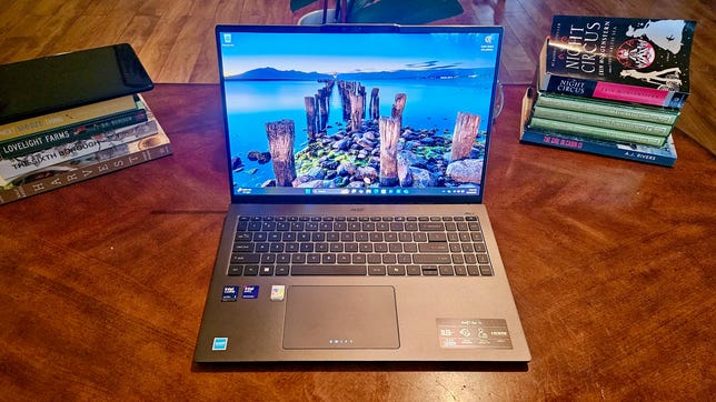 Acer Swift Go 16 laptop on a desk with books