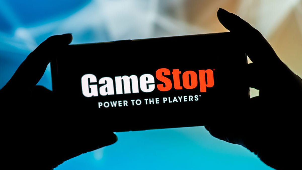 GameStop logo on a smartphone in silhouette